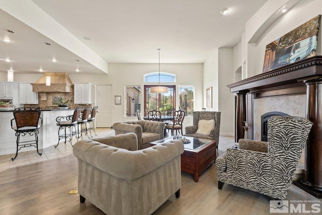 living room with light hardwood / wood-style flooring and a fireplace