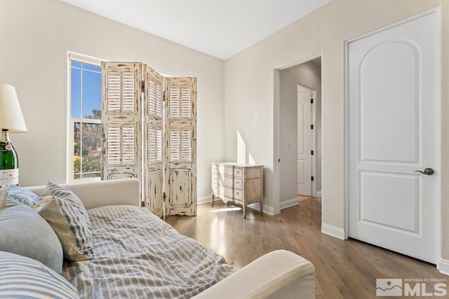 bedroom featuring hardwood / wood-style flooring and vaulted ceiling