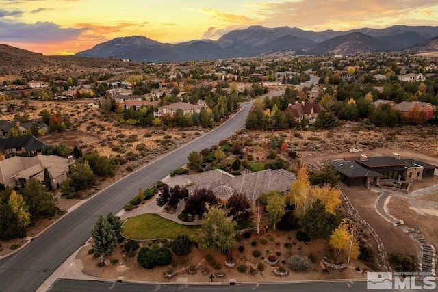 aerial view at dusk featuring a mountain view