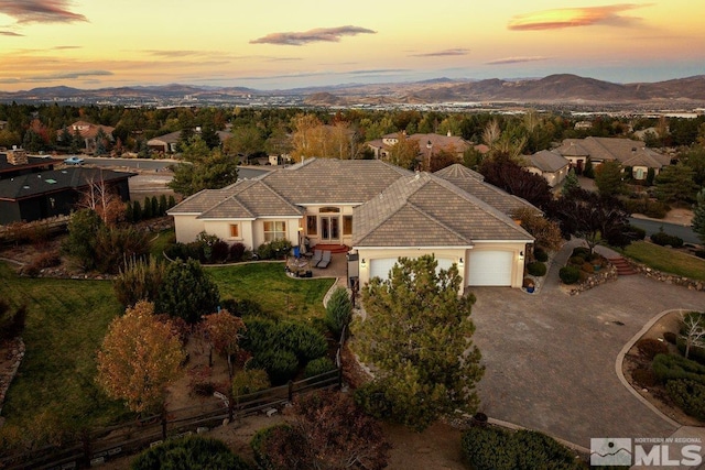 aerial view at dusk featuring a mountain view