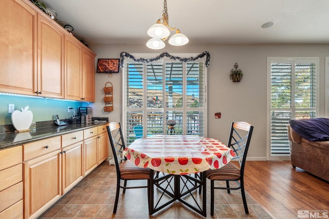 dining space featuring hardwood / wood-style flooring and an inviting chandelier