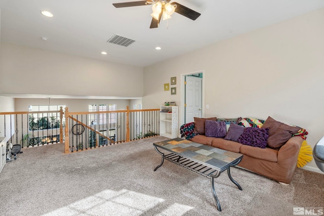 carpeted living room with ceiling fan