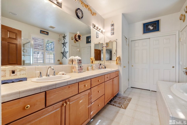 bathroom featuring vanity and separate shower and tub