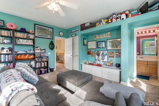 living room with light colored carpet, sink, and ceiling fan