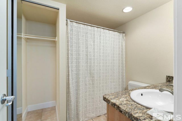 bathroom with vanity, toilet, and tile patterned floors