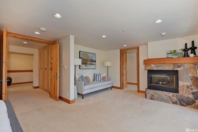 living room with light colored carpet and a fireplace