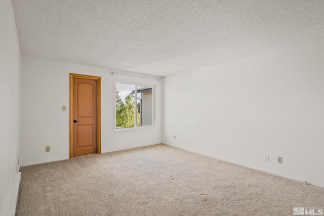 carpeted spare room with a textured ceiling