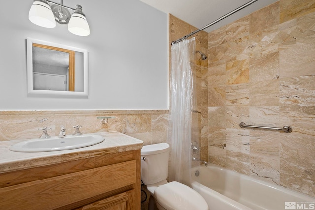 full bathroom with vanity, toilet, tile walls, and shower / bath combo