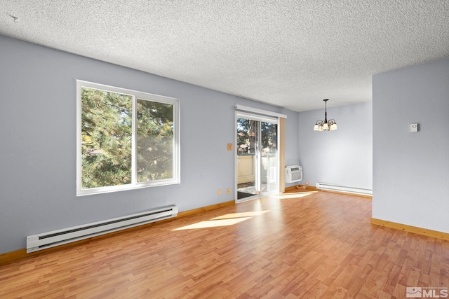 unfurnished room featuring light hardwood / wood-style floors, a textured ceiling, a chandelier, and a baseboard radiator