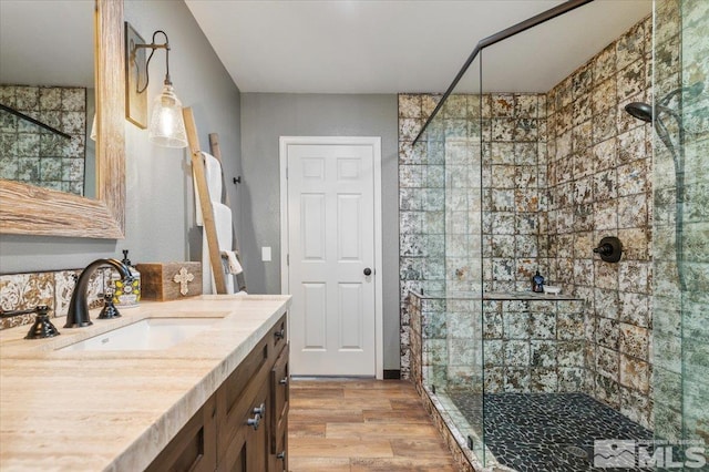 bathroom featuring vanity, a shower with shower door, and hardwood / wood-style flooring