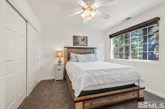 carpeted bedroom featuring a closet and ceiling fan