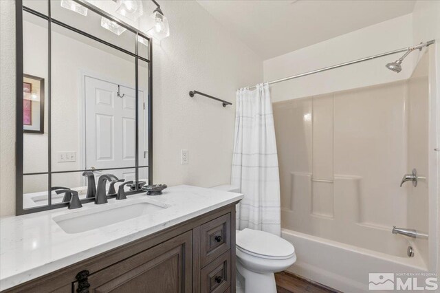 full bathroom featuring toilet, shower / bath combo, hardwood / wood-style flooring, and vanity