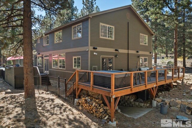 rear view of property featuring a deck