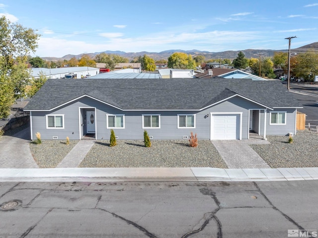 single story home featuring a garage and a mountain view