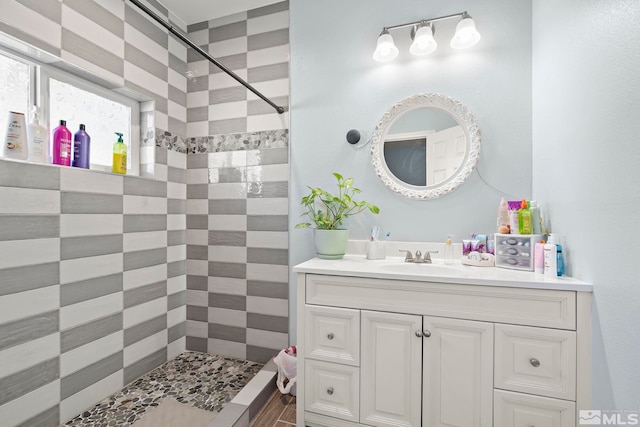 bathroom featuring vanity and a tile shower