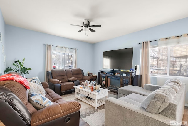 living room with ceiling fan and a wealth of natural light