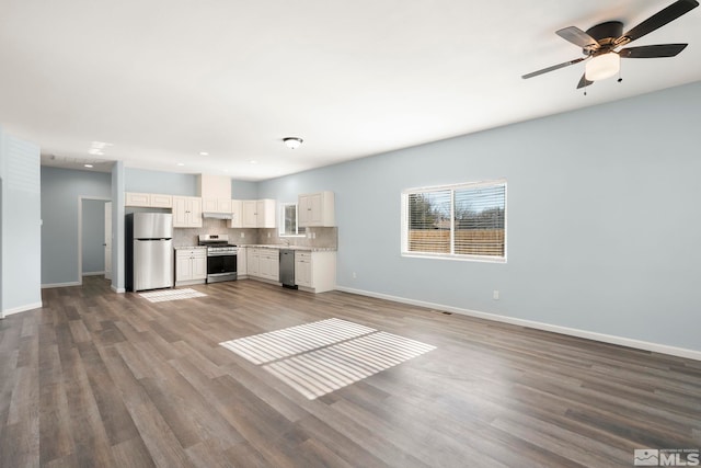 unfurnished living room featuring ceiling fan and hardwood / wood-style floors