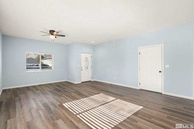 unfurnished living room featuring ceiling fan and dark hardwood / wood-style floors