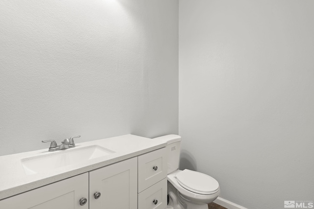 bathroom with toilet and vanity