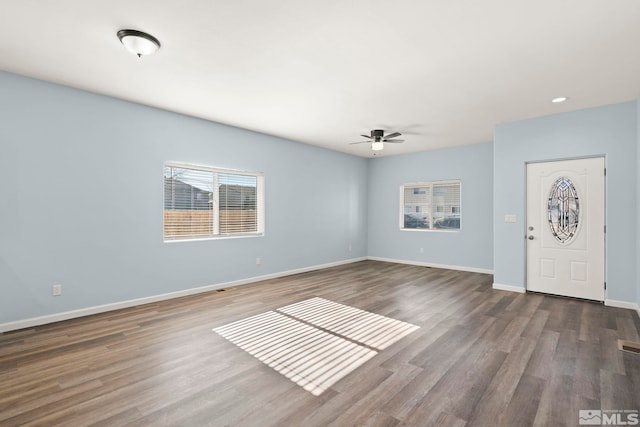 interior space featuring ceiling fan and dark wood-type flooring