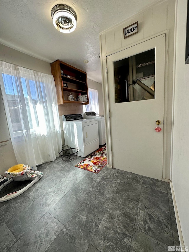 washroom featuring washer and dryer and a textured ceiling