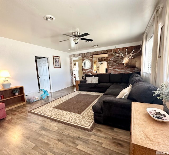 living room featuring hardwood / wood-style floors and ceiling fan