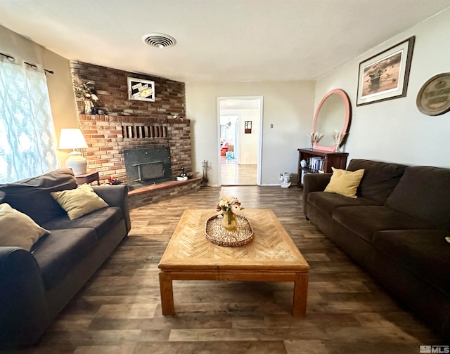 living room with a fireplace and dark hardwood / wood-style floors