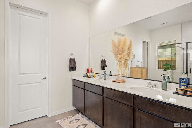 bathroom featuring vanity, tile patterned floors, and a shower with door