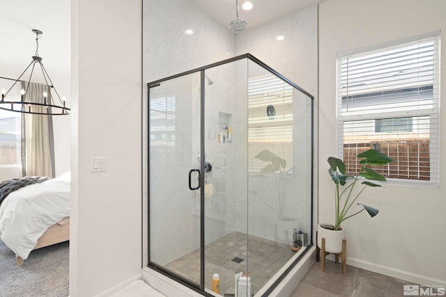 bathroom featuring walk in shower and an inviting chandelier