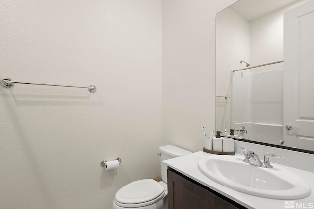 bathroom featuring vanity, toilet, and a shower