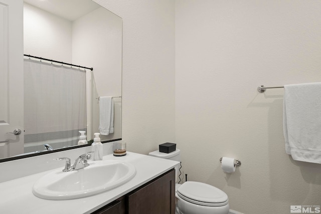 bathroom featuring vanity and toilet