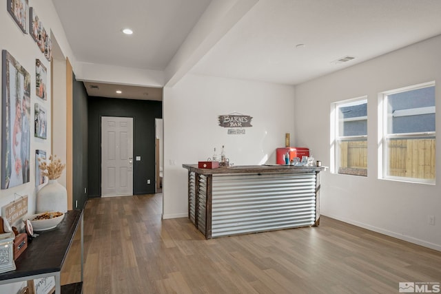 bar with wood-type flooring