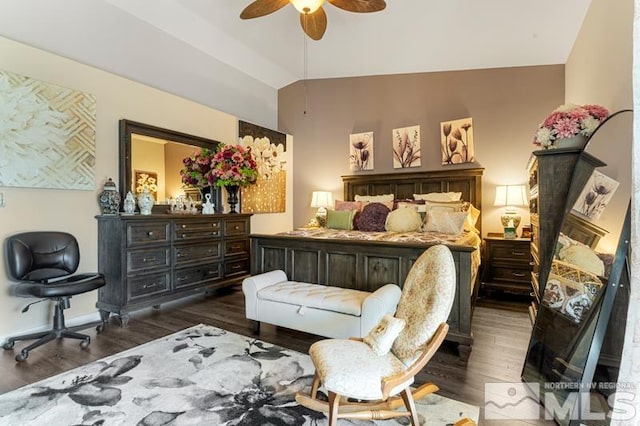 bedroom with dark wood-type flooring, vaulted ceiling, and ceiling fan