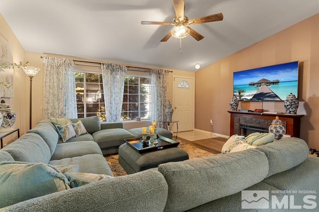 living room with ceiling fan, hardwood / wood-style flooring, and lofted ceiling