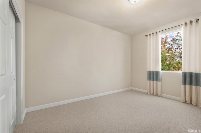 unfurnished room featuring carpet