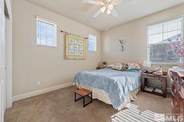 carpeted bedroom featuring a closet, ceiling fan, and multiple windows