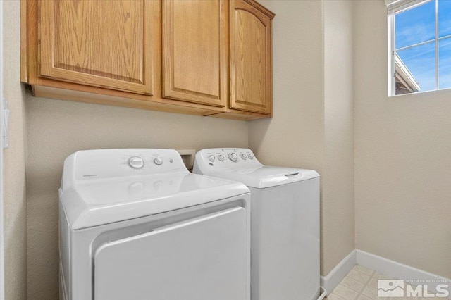 washroom featuring washing machine and dryer and cabinets