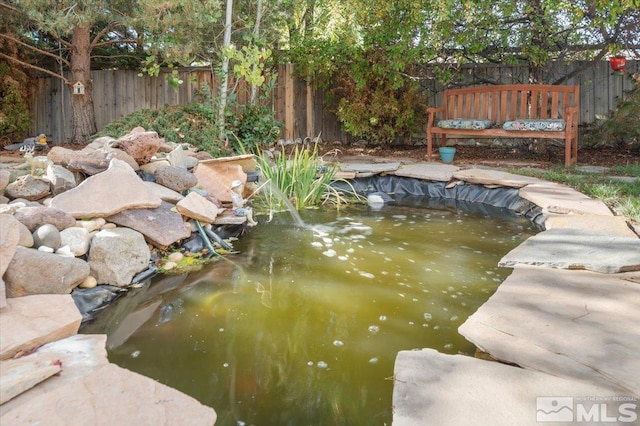 exterior space featuring a garden pond