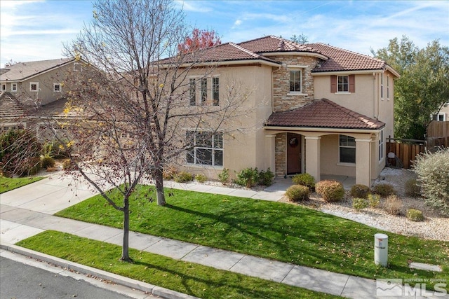 mediterranean / spanish house with a front lawn