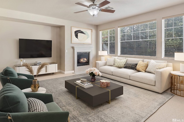 carpeted living room with ceiling fan