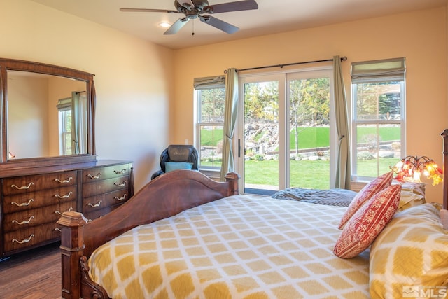 bedroom with dark wood-type flooring, multiple windows, access to outside, and ceiling fan