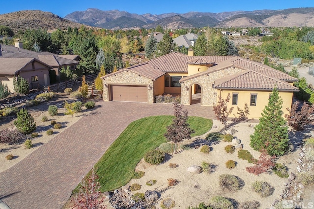 view of front of property with a garage and a mountain view