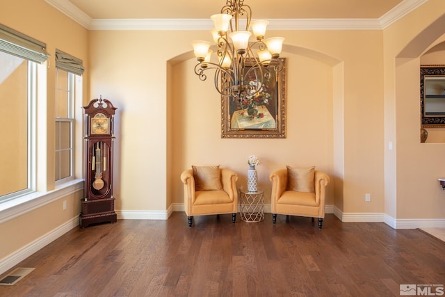 sitting room with crown molding, dark hardwood / wood-style flooring, and a chandelier