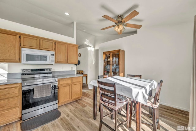 kitchen featuring ceiling fan, stainless steel range with electric stovetop, and light wood-type flooring