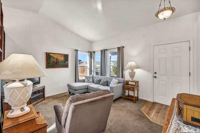 carpeted living room with lofted ceiling