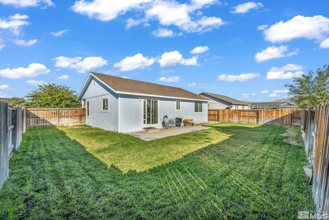 rear view of property featuring a patio and a lawn