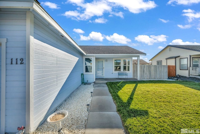 property entrance featuring a lawn