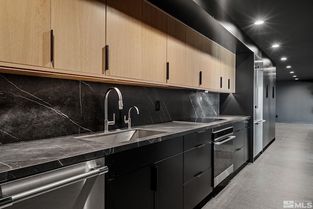 kitchen featuring light brown cabinetry, appliances with stainless steel finishes, sink, and backsplash