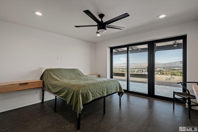 bedroom featuring ceiling fan, a mountain view, and access to exterior