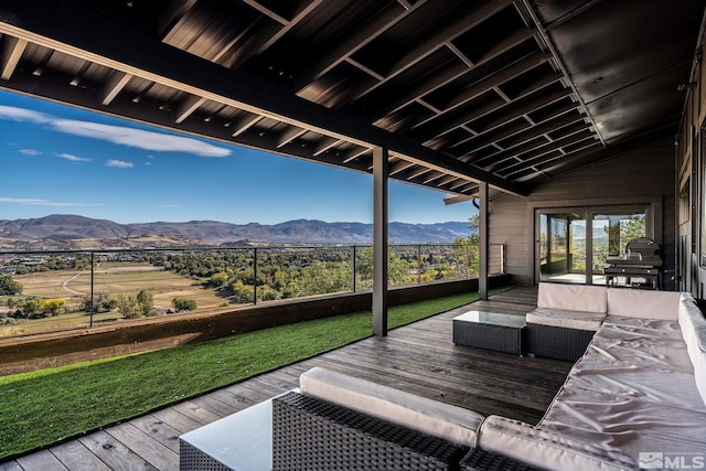 wooden deck featuring an outdoor living space and a mountain view